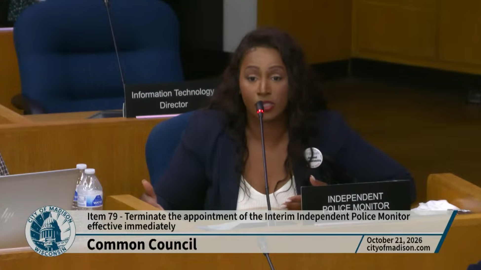 Interim Independent Police Monitor Aeiramique Glass sitting in front of a microphone, speaking at a Madison Common Council meeting